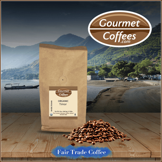 A bag of Gourmet Coffees.com Organic Timor Fair Trade Coffee with a scenic background featuring mountains and a boat.